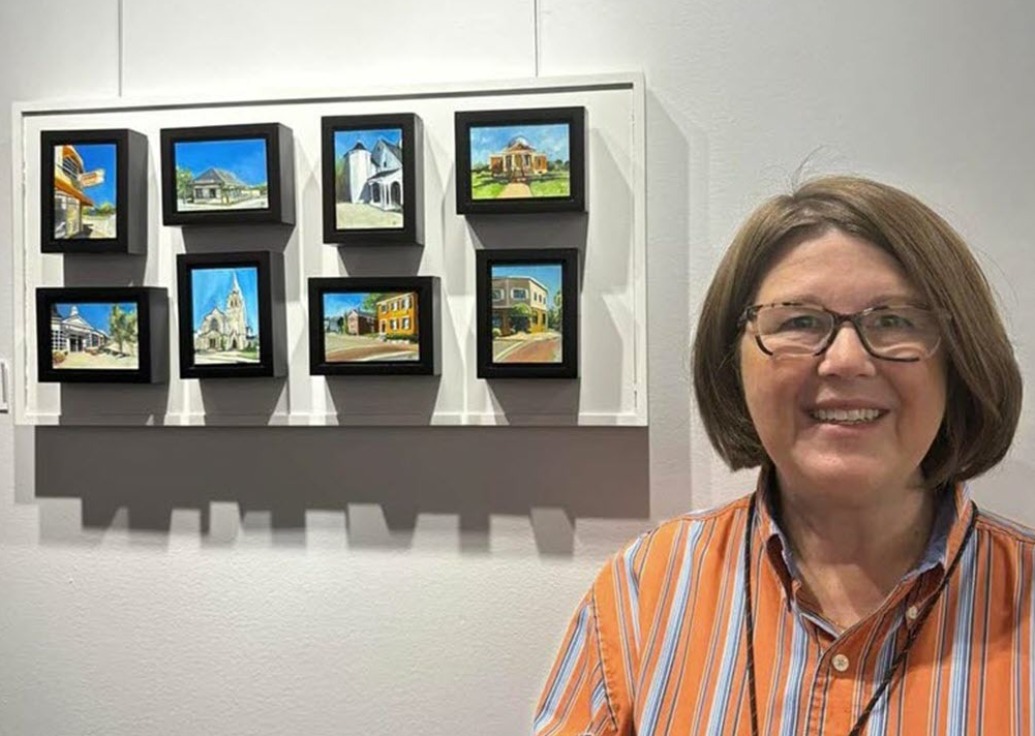 Artist DeeDee Bernhardt next to her "tiny paintings"